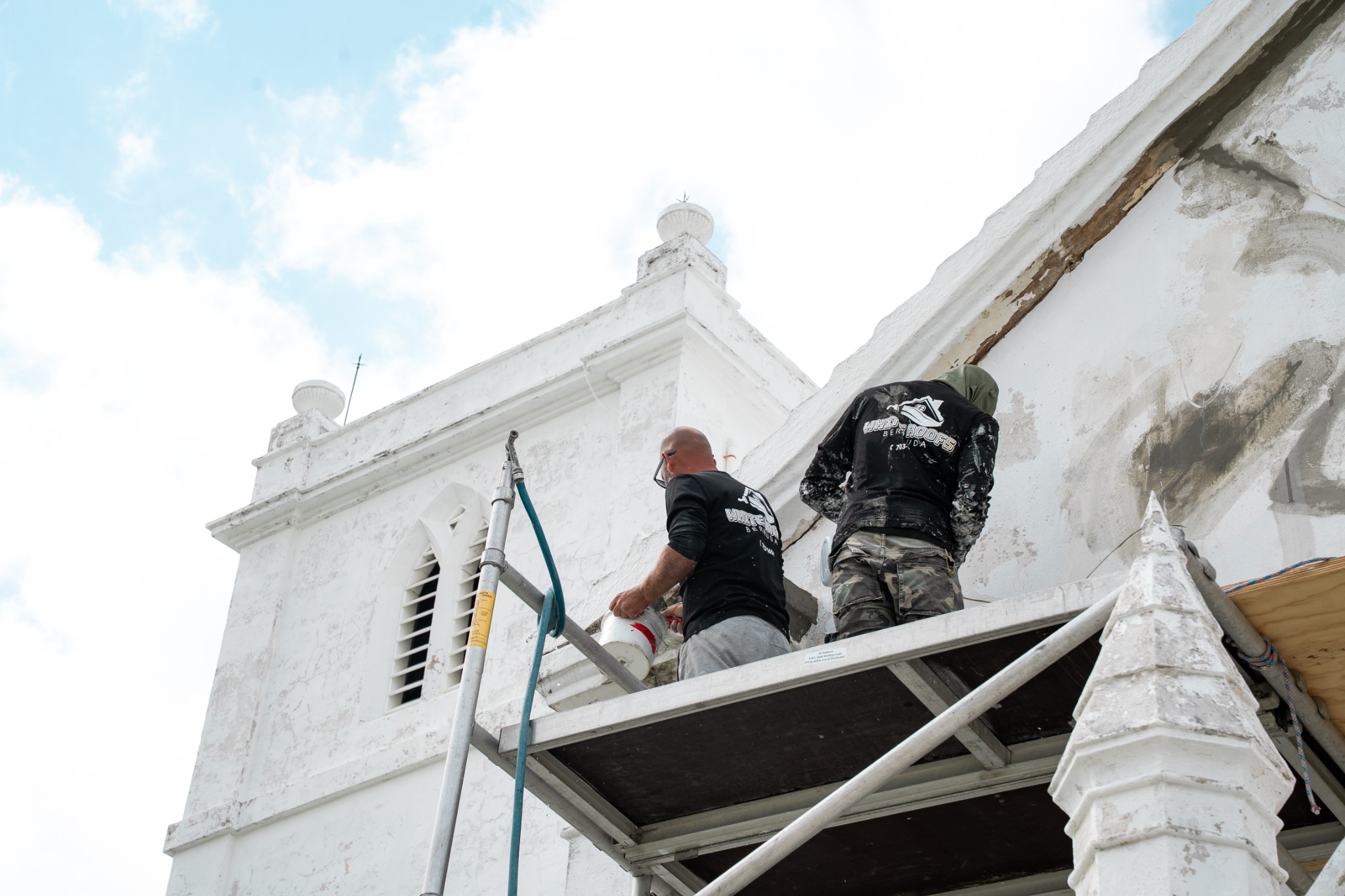 White Roofs team carrying out exterior restoration work on a Bermuda church