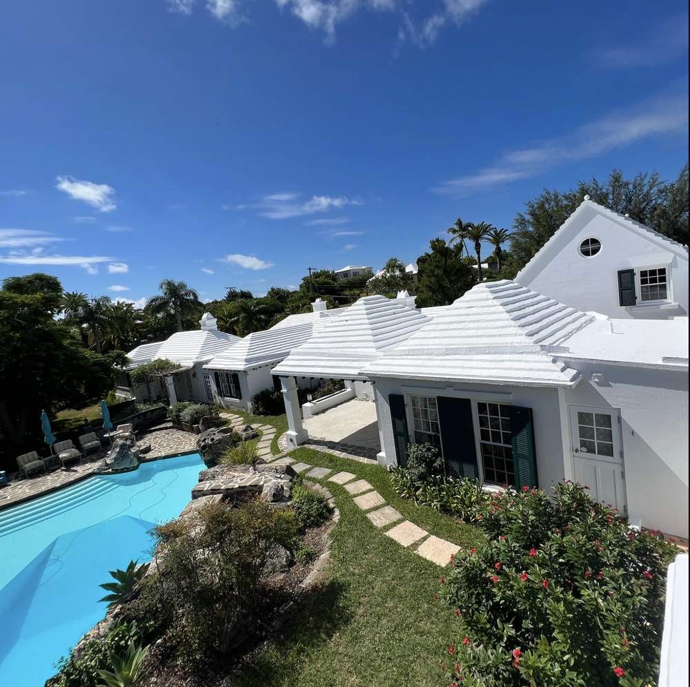 White stepped Bermuda roof over a poolside home